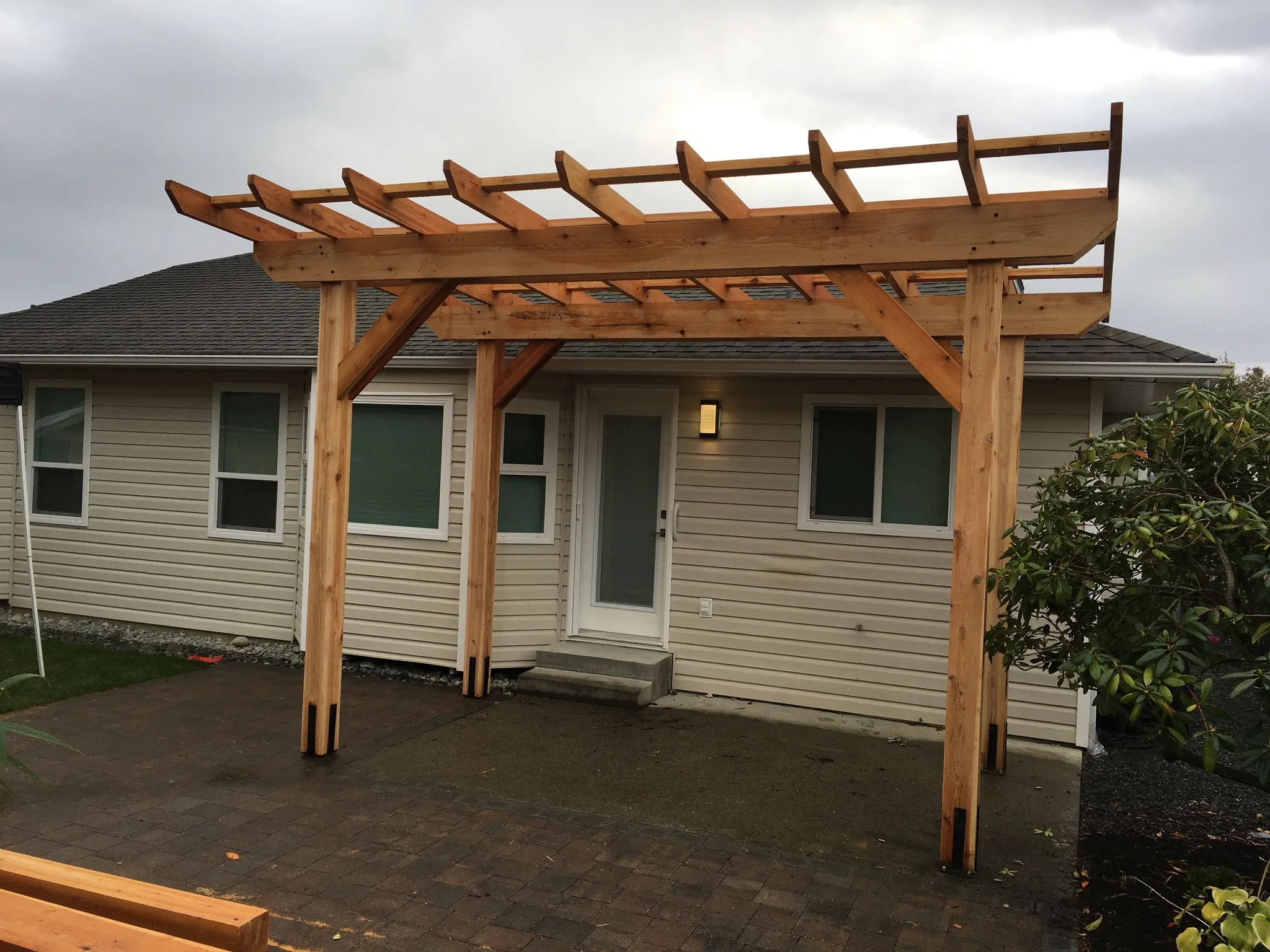 Cedar pergola built over a back patio door