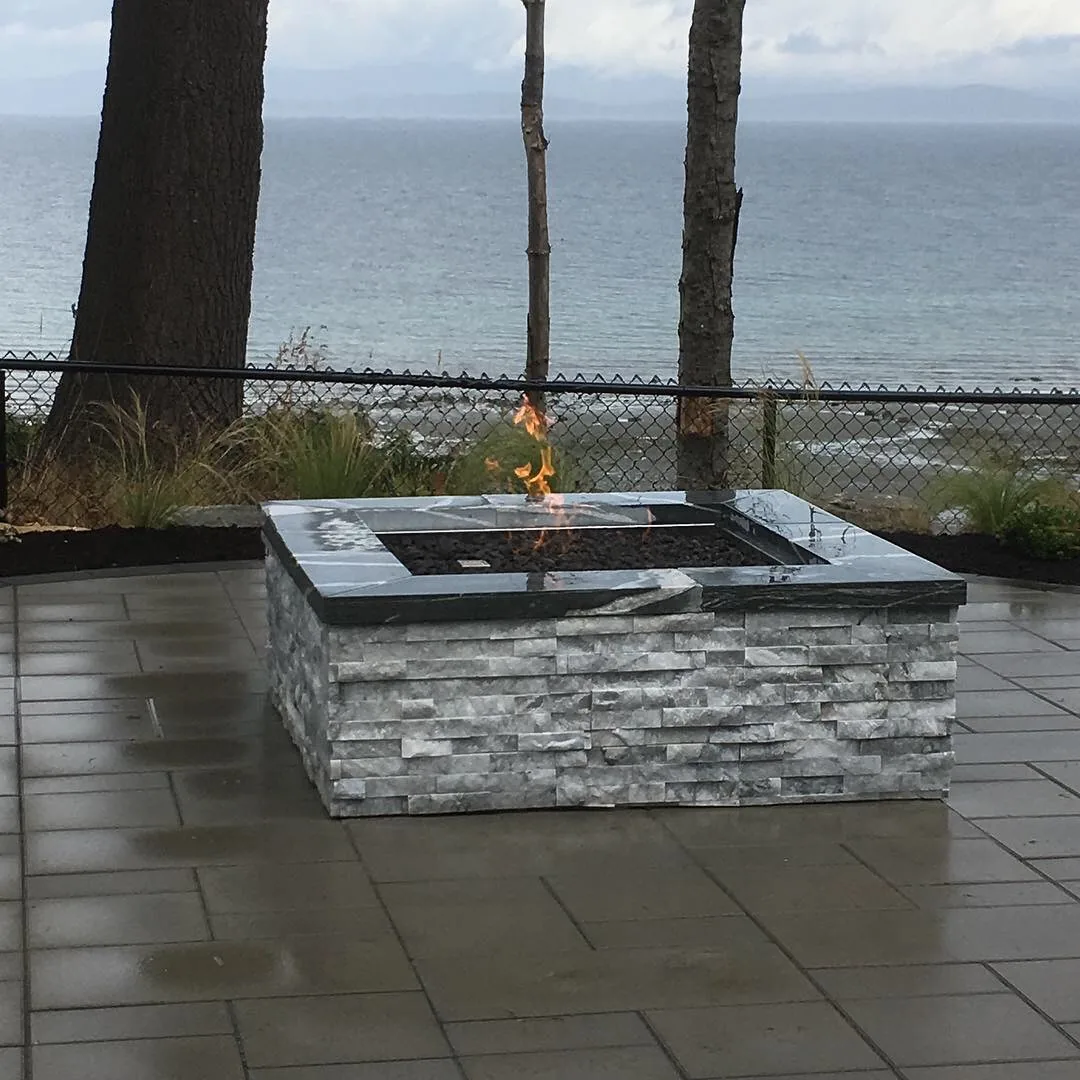 Fire table on a paver terrace overlooking the water