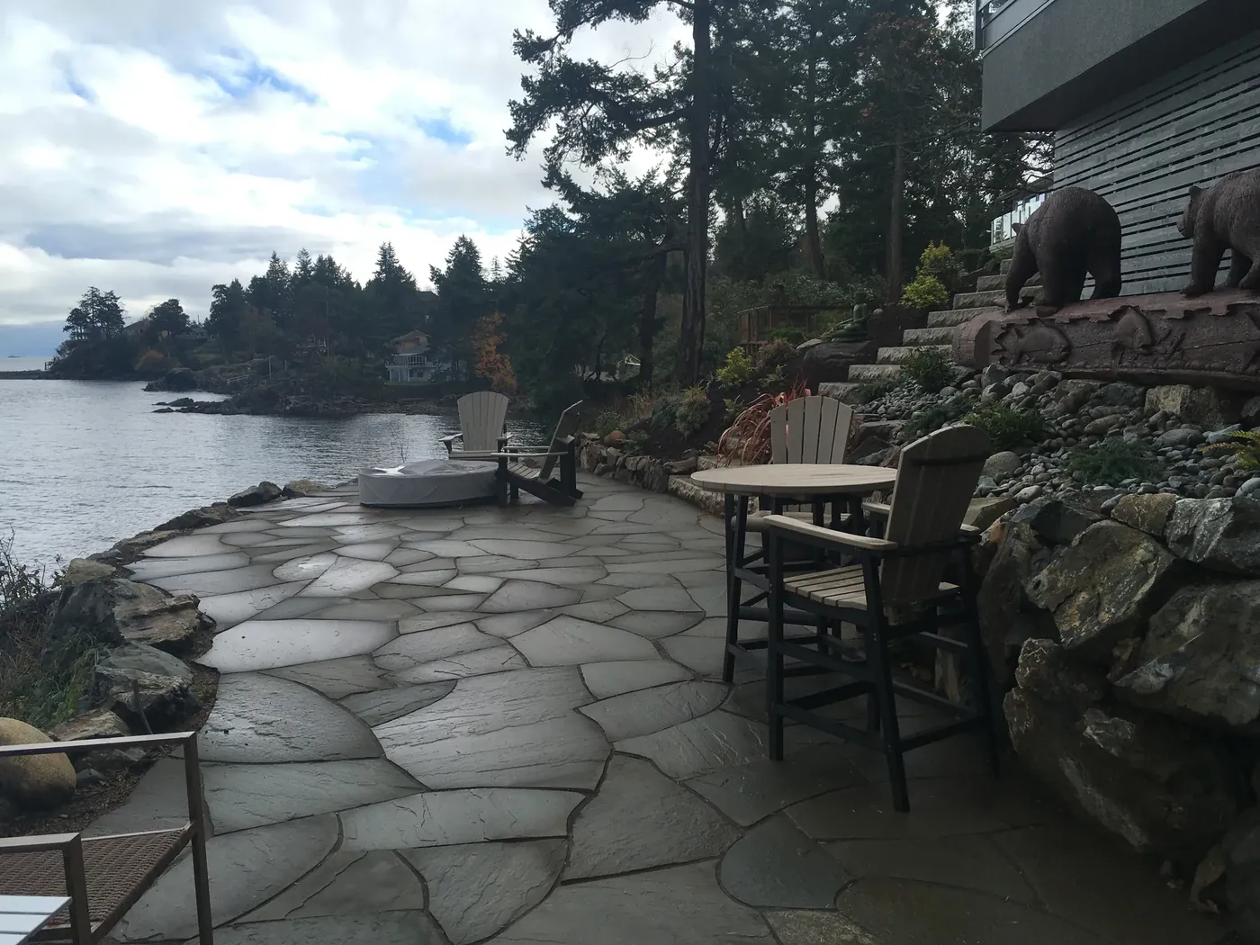 Flagstone patio with seating looking out over the water
